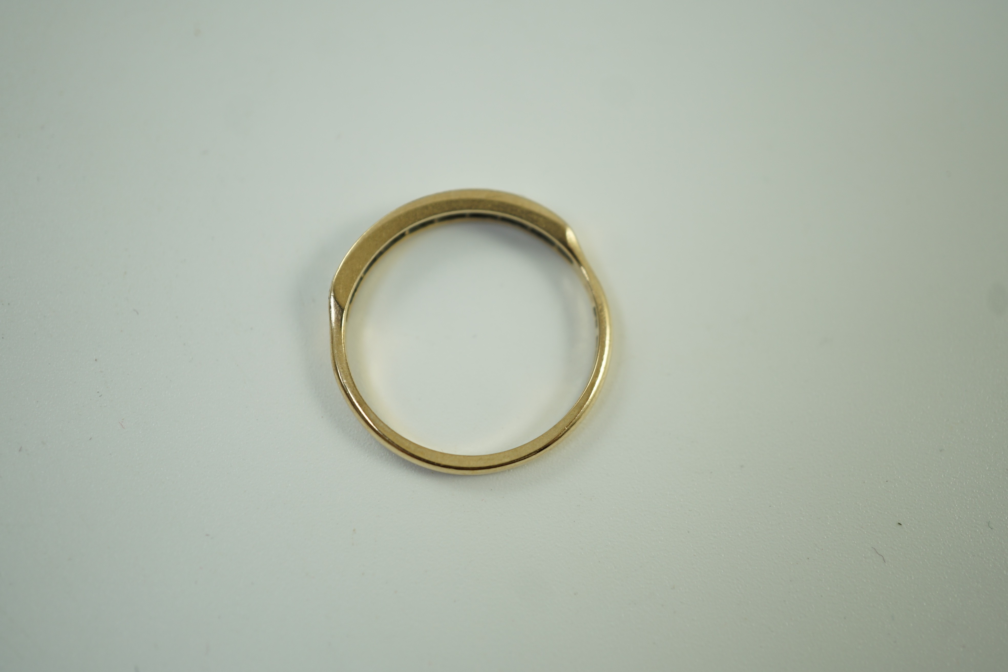 A modern 9ct gold and eight stone diamond chip set half hoop ring, size O, gross weight 1.6 grams.